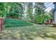 Expansive backyard with a manicured lawn, mature trees, and privacy fence at 2604 Porchside Se Pl, Atlanta, GA 30316
