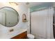 Well-lit bathroom with modern vanity, round mirror, and stylish shower curtain at 2604 Porchside Se Pl, Atlanta, GA 30316