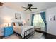 Bright bedroom with a queen bed, blue accents, and natural light from the window at 2604 Porchside Se Pl, Atlanta, GA 30316