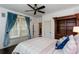 Cozy bedroom with natural light, a queen bed, a ceiling fan, and blue curtains at 2604 Porchside Se Pl, Atlanta, GA 30316