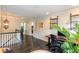 Second floor landing featuring hardwood floors, an ornate light fixture, and a view of the office and laundry at 2604 Porchside Se Pl, Atlanta, GA 30316