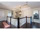 Upstairs hallway featuring dark hardwood floors, a decorative light fixture, and a laundry closet at 2604 Porchside Se Pl, Atlanta, GA 30316