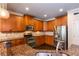 Kitchen with granite counters, stainless appliances and dark wood floors at 2604 Porchside Se Pl, Atlanta, GA 30316