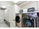 Functional laundry room area featuring a modern washer and dryer set, closet space, and tile flooring at 2604 Porchside Se Pl, Atlanta, GA 30316