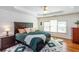 Serene main bedroom featuring a ceiling fan, a king bed, shiplap accent wall, and an abundance of natural light at 2604 Porchside Se Pl, Atlanta, GA 30316