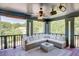 Covered porch with comfortable seating and a view of the mature trees at 2604 Porchside Se Pl, Atlanta, GA 30316