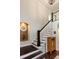 Elegant staircase with dark wood treads, white risers and railing and a decorative alcove with mirror at 2604 Porchside Se Pl, Atlanta, GA 30316
