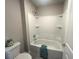 Clean and bright bathroom showcasing a built-in tub-shower combination with sleek, white surround at 4040 Sierra Vista Cir, Cumming, GA 30040