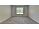 Spacious bedroom with soft carpet and natural light from the window at 4040 Sierra Vista Cir, Cumming, GA 30040