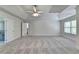 Large primary bedroom featuring trey ceiling, neutral paint, modern ceiling fan, carpeted floors, and a large window at 4040 Sierra Vista Cir, Cumming, GA 30040