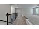 Loft area with stairway and an adjacent open space with a large window at 4040 Sierra Vista Cir, Cumming, GA 30040