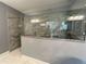 Modern bathroom featuring a glass shower, gray tiling, granite counter, and hand rails at 43 Wickford Way, Villa Rica, GA 30180