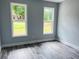 Bedroom with views from two windows of front yard and luxury vinyl plank flooring at 43 Wickford Way, Villa Rica, GA 30180