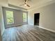 Spacious bedroom featuring a ceiling fan, two windows, and luxury vinyl plank flooring at 43 Wickford Way, Villa Rica, GA 30180