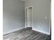 Bedroom with gray walls, luxury vinyl plank flooring, and open doorway at 43 Wickford Way, Villa Rica, GA 30180