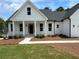 Charming home featuring a covered front porch with stately columns and fresh landscaping at 43 Wickford Way, Villa Rica, GA 30180