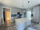 Modern kitchen with gray cabinets and a large island featuring a white countertop at 43 Wickford Way, Villa Rica, GA 30180