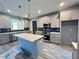 Modern kitchen with gray cabinets, stainless steel appliances, and a center island with quartz countertop at 43 Wickford Way, Villa Rica, GA 30180