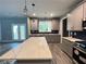 Spacious kitchen features a central island, modern cabinets, and stainless steel appliances at 43 Wickford Way, Villa Rica, GA 30180