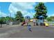 Community playground with slides, swings, and climbing structures surrounded by green trees at 43 Wickford Way, Villa Rica, GA 30180