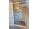 Glass enclosed shower with marble-style tile and built-in shampoo niche at 43 Wickford Way, Villa Rica, GA 30180
