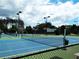 Tennis courts with a net and blue surface, inviting for a friendly match at 43 Wickford Way, Villa Rica, GA 30180
