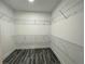 Walk-in closet with white wire shelving and luxury vinyl plank flooring at 43 Wickford Way, Villa Rica, GA 30180