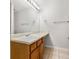 Well-lit bathroom features a large mirror, wood cabinets, and tile floors at 4370 Stone Gate Way # 97, Atlanta, GA 30344