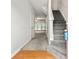 Bright foyer with hardwood floors, stairs leading up, and a view into a spacious living area at 4370 Stone Gate Way # 97, Atlanta, GA 30344