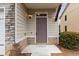 Inviting entryway featuring stone accents, a charming door, and a neatly maintained bush at 4370 Stone Gate Way # 97, Atlanta, GA 30344