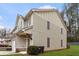 Side view of a charming townhouse featuring neutral siding, decorative shutters, and tidy landscaping at 4370 Stone Gate Way # 97, Atlanta, GA 30344