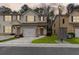 Inviting townhouse showcasing neutral siding, decorative shutters, and a manicured lawn at 4370 Stone Gate Way # 97, Atlanta, GA 30344