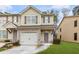 Charming two-story townhouse with stone accents, a garage, and a well-maintained front lawn at 4370 Stone Gate Way # 97, Atlanta, GA 30344