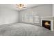 Spacious living room with a fireplace, carpet, and French doors leading to a deck at 4370 Stone Gate Way # 97, Atlanta, GA 30344
