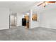 Open-concept living area with carpet and views to the kitchen area at 4370 Stone Gate Way # 97, Atlanta, GA 30344