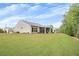 Expansive backyard features lush green lawn, mature trees, and a screened porch for outdoor enjoyment at 448 Marston Pass, Acworth, GA 30102