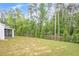 Large, level backyard bordered by mature trees offers privacy and space for recreation and landscaping at 448 Marston Pass, Acworth, GA 30102