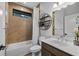 Bathroom showing shower-tub combination, tile walls, large mirror, and sink at 448 Marston Pass, Acworth, GA 30102
