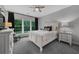 Bedroom with white furniture, neutral walls and carpets, large windows and ceiling fan at 448 Marston Pass, Acworth, GA 30102