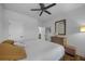 Neutral bedroom offers plush queen bed, hardwood floor, ceiling fan, and ample light at 448 Marston Pass, Acworth, GA 30102