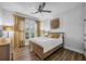 Comfortable bedroom features hardwood floor, natural light, and ceiling fan at 448 Marston Pass, Acworth, GA 30102