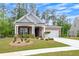 Attractive home featuring a brick facade, dormer windows, and lush green landscaping at 448 Marston Pass, Acworth, GA 30102