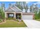 Charming brick and gray home with a well-manicured lawn and attached two-car garage at 448 Marston Pass, Acworth, GA 30102