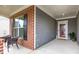 Cozy front porch featuring brick columns, wicker chairs, and a view of the entrance at 448 Marston Pass, Acworth, GA 30102