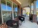 Inviting front porch with brick columns, dark wicker seating, and well-maintained landscaping at 448 Marston Pass, Acworth, GA 30102
