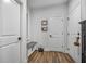 Hallway with wood floors, white doors, bench seat, and coat rack at 448 Marston Pass, Acworth, GA 30102