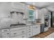 Modern kitchen featuring granite countertops, stainless steel appliances, and a white tile backsplash at 448 Marston Pass, Acworth, GA 30102