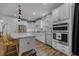 Bright kitchen with white cabinets, granite countertops, stainless steel appliances, and a center island at 448 Marston Pass, Acworth, GA 30102