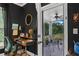 Bright office featuring dark walls, a desk, an office chair and access to an outdoor screened-in porch at 448 Marston Pass, Acworth, GA 30102
