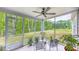 Covered outdoor patio with gray concrete floor, outdoor seating, ceiling fan, and a green lawn view at 448 Marston Pass, Acworth, GA 30102